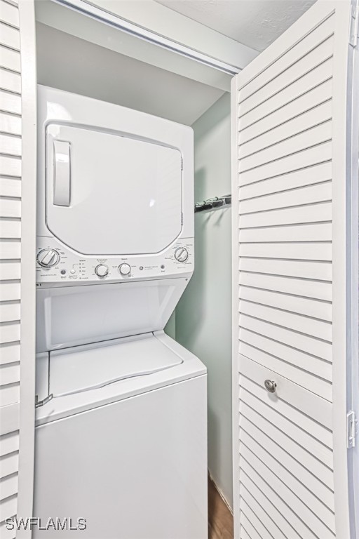 washroom featuring stacked washer / dryer