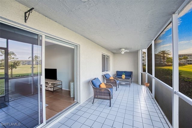 sunroom featuring ceiling fan