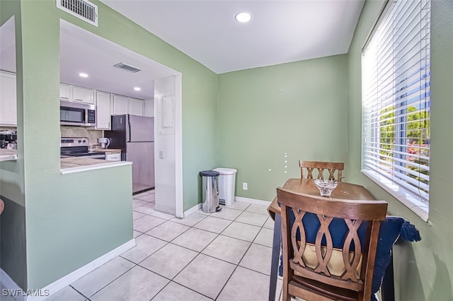 tiled dining area featuring plenty of natural light