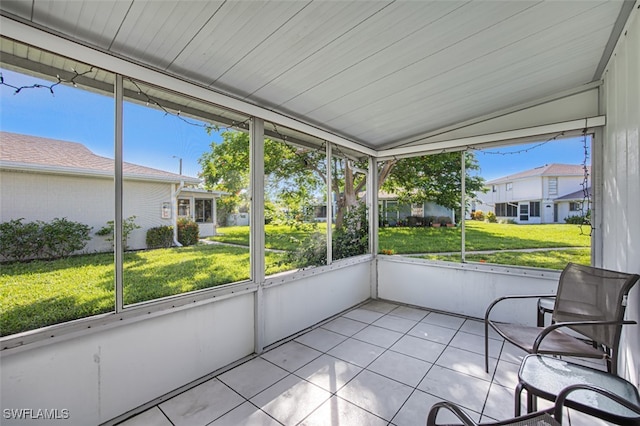 unfurnished sunroom featuring lofted ceiling