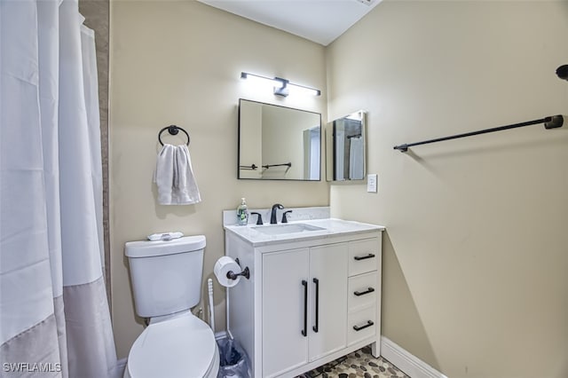 bathroom featuring toilet and vanity