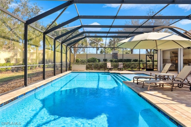 view of swimming pool featuring a patio and glass enclosure