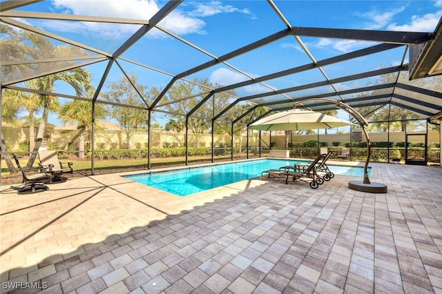 view of swimming pool with a lanai and a patio