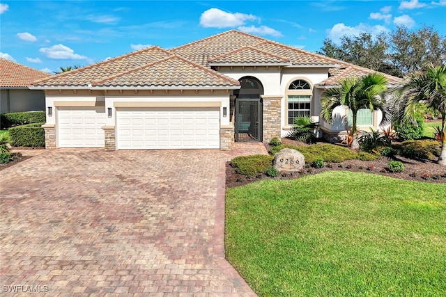 mediterranean / spanish house with a garage and a front yard