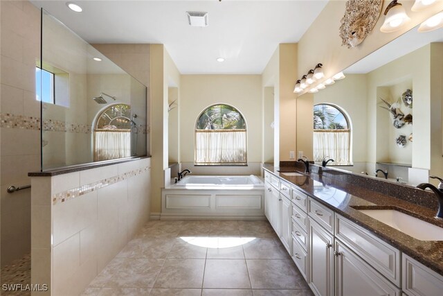 bathroom featuring vanity, shower with separate bathtub, and tile patterned flooring