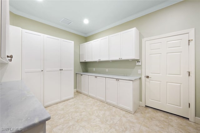 kitchen with crown molding and white cabinets