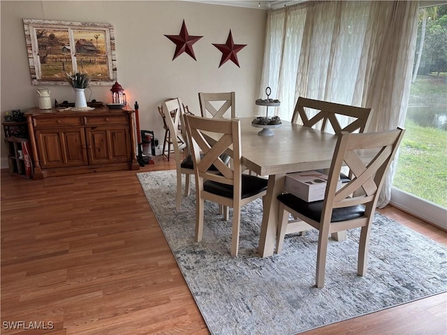 dining area with a healthy amount of sunlight and hardwood / wood-style flooring