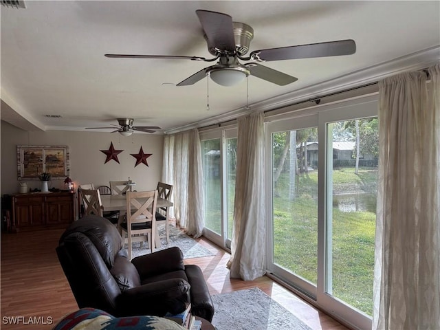 sunroom featuring ceiling fan