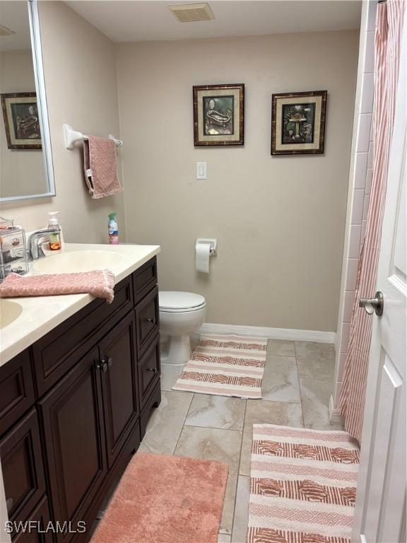 bathroom with toilet and vanity