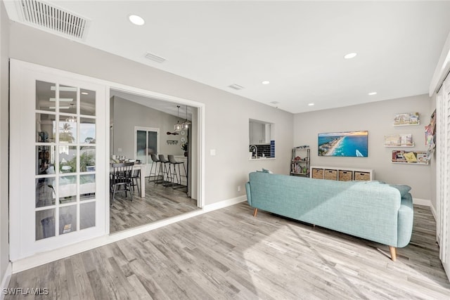 738 101st Ave N, Naples, FL 34108 - living room with baseboards, wood finished floors, a chandelier, and recessed lighting