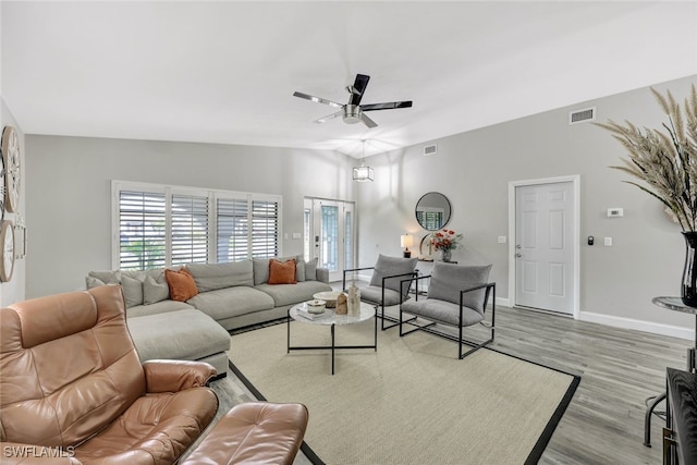 738 101st Ave N, Naples, FL 34108 - living area with a ceiling fan, light wood-style flooring, and baseboards