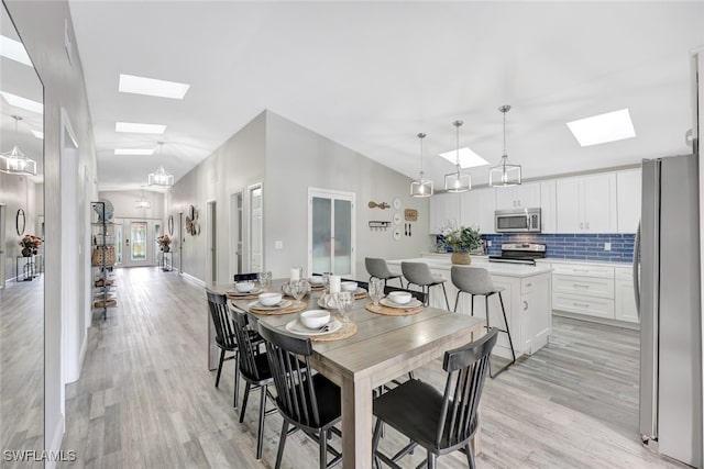 738 101st Ave N, Naples, FL 34108 - dining area with a skylight, light wood finished floors, and lofted ceiling