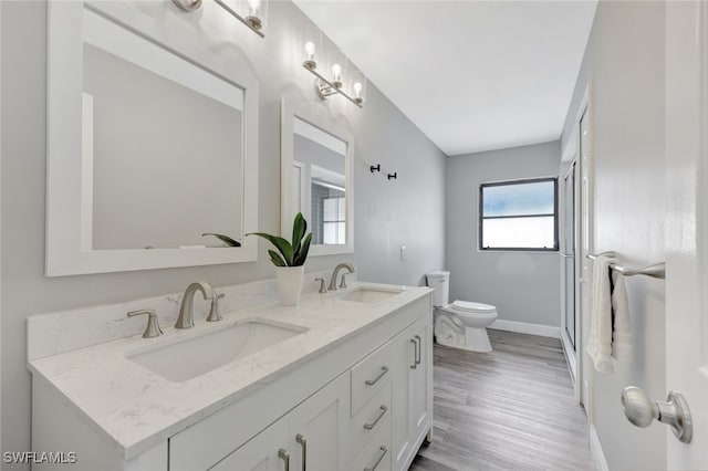 738 101st Ave N, Naples, FL 34108 - full bath featuring toilet, double vanity, wood finished floors, and baseboards