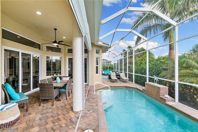 view of swimming pool featuring an outdoor living space, a lanai, a patio area, and ceiling fan