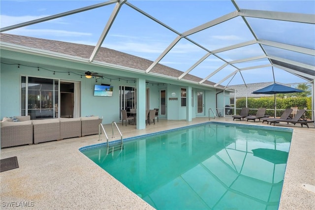 view of swimming pool with ceiling fan, an outdoor hangout area, a patio, and a lanai