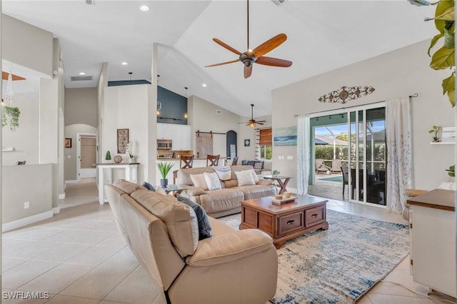 tiled living room with high vaulted ceiling, a barn door, and ceiling fan