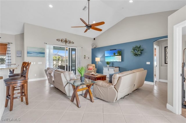 living room featuring ceiling fan, light tile patterned floors, and vaulted ceiling