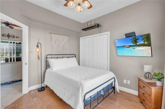 bedroom with ceiling fan, a closet, and light wood-type flooring