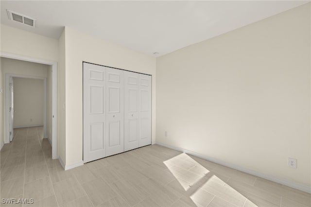 unfurnished bedroom with a closet