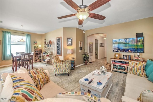 living room featuring ceiling fan and light wood-type flooring