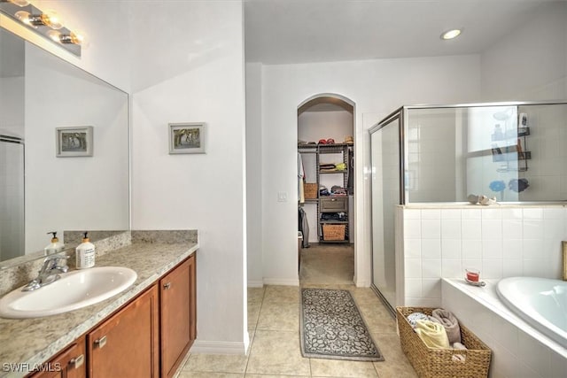 bathroom featuring tile patterned floors, vanity, and independent shower and bath