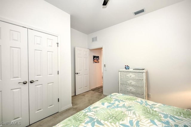 bedroom featuring ceiling fan, a closet, and light carpet