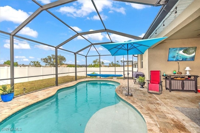 view of swimming pool featuring a lanai and a patio