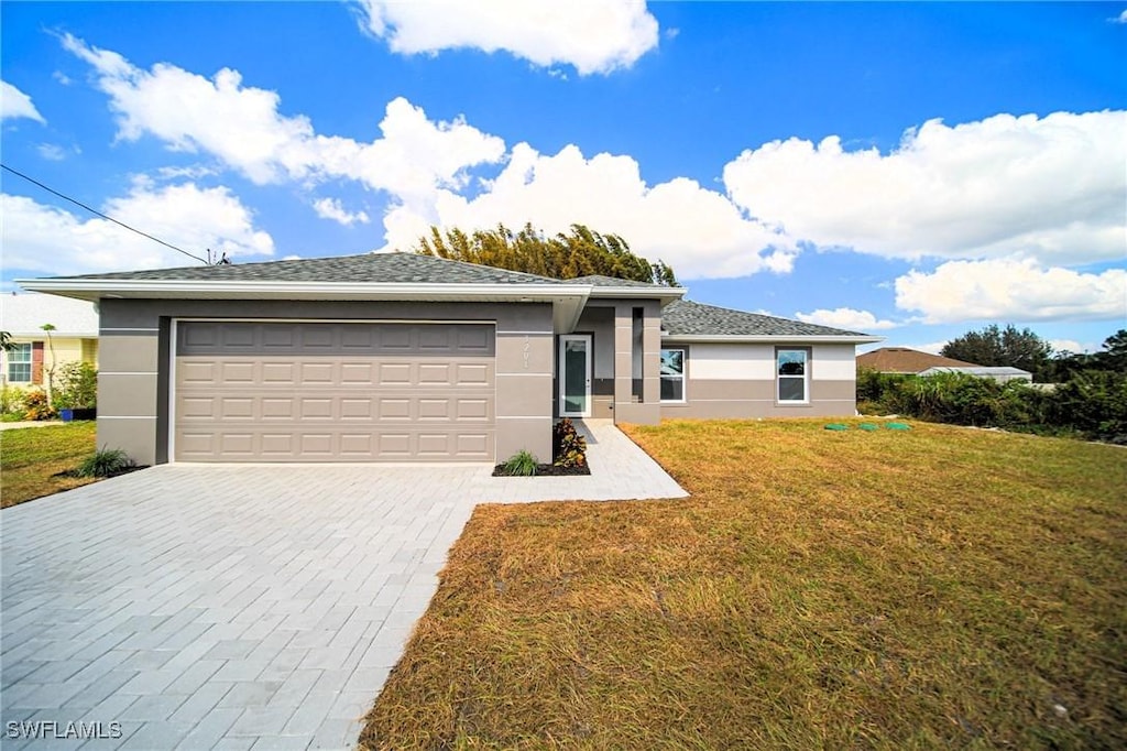 view of front facade with a front yard and a garage