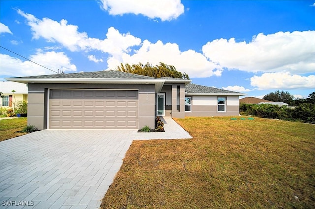 view of front facade with a front yard and a garage