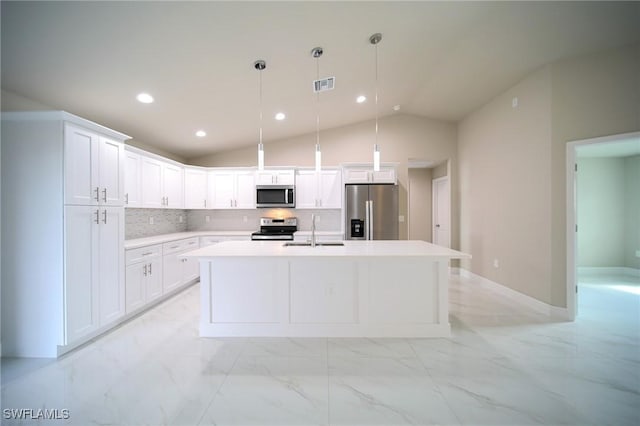 kitchen with pendant lighting, appliances with stainless steel finishes, lofted ceiling, white cabinetry, and tasteful backsplash