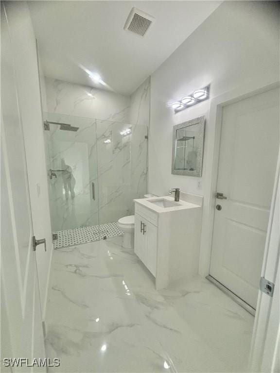 bathroom with toilet, vanity, and an enclosed shower