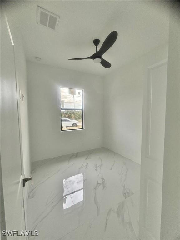 3204 20th St SW, Lehigh Acres, FL 33976 - empty room featuring marble finish floors and ceiling fan