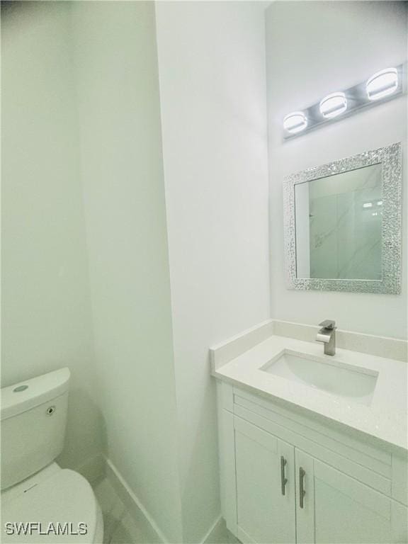 bathroom featuring toilet and vanity