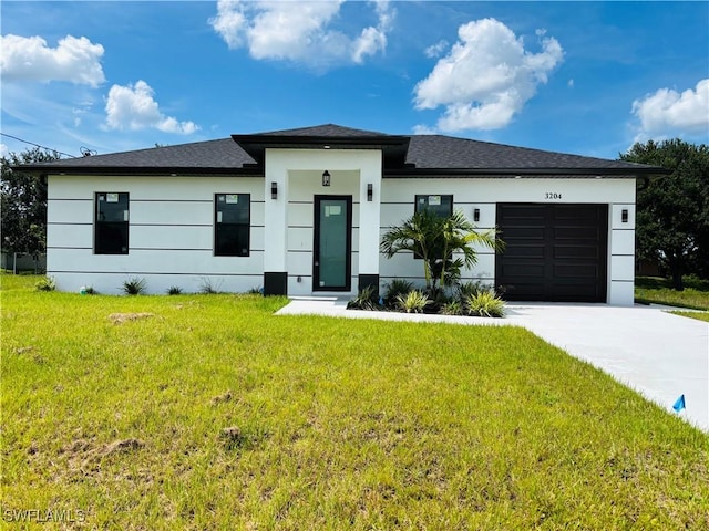 3204 20th St SW, Lehigh Acres, FL 33976 - prairie-style home with driveway, an attached garage, a front lawn, and stucco siding