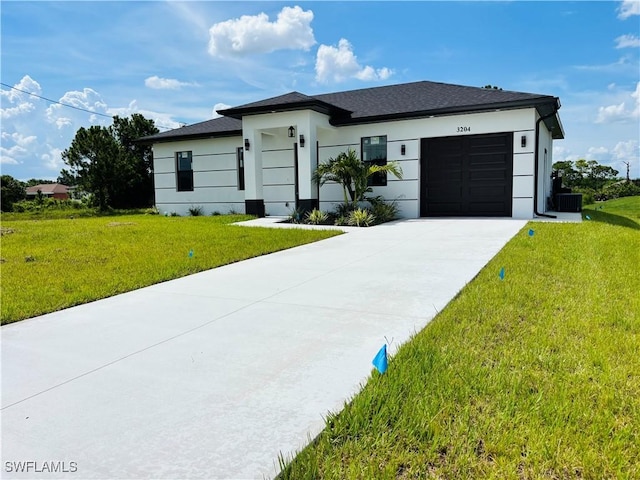 3204 20th St SW, Lehigh Acres, FL 33976 - view of front of house with a garage, a front yard, concrete driveway, and stucco siding