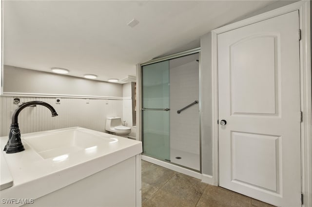 bathroom with toilet, vanity, and an enclosed shower