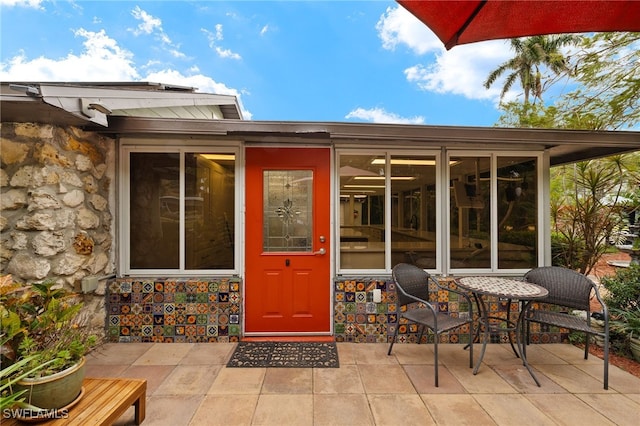 entrance to property featuring a patio area