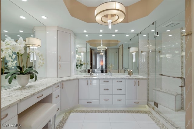 bathroom with tile patterned floors, vanity, and an enclosed shower