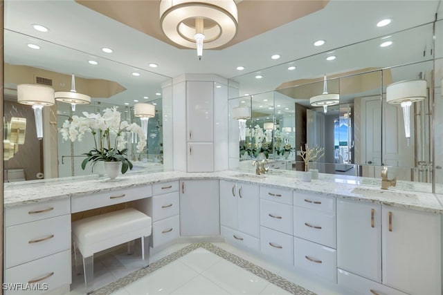 bathroom featuring toilet, vanity, and tile patterned flooring