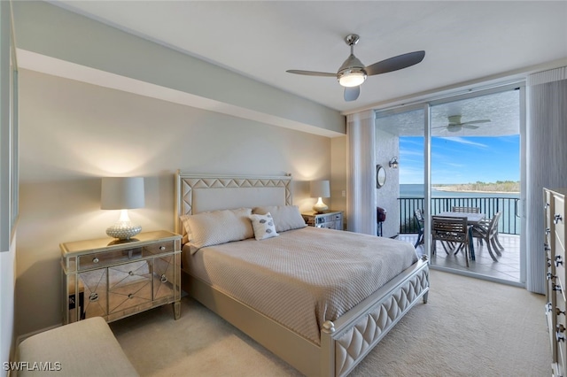 carpeted bedroom featuring a water view, ceiling fan, and access to exterior