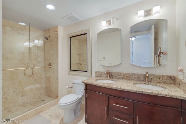 bathroom featuring toilet, vanity, tile patterned flooring, and a shower with door