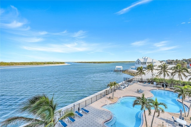 view of swimming pool with a water view and a patio