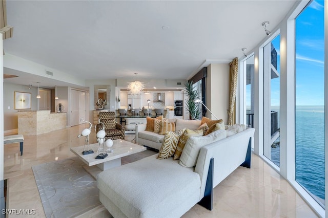 living room featuring a water view and floor to ceiling windows