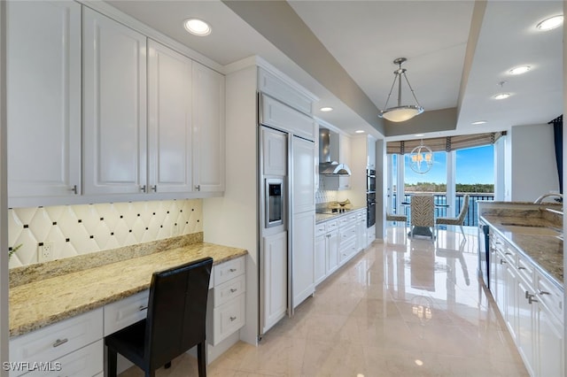 kitchen with decorative backsplash, pendant lighting, white cabinets, and sink