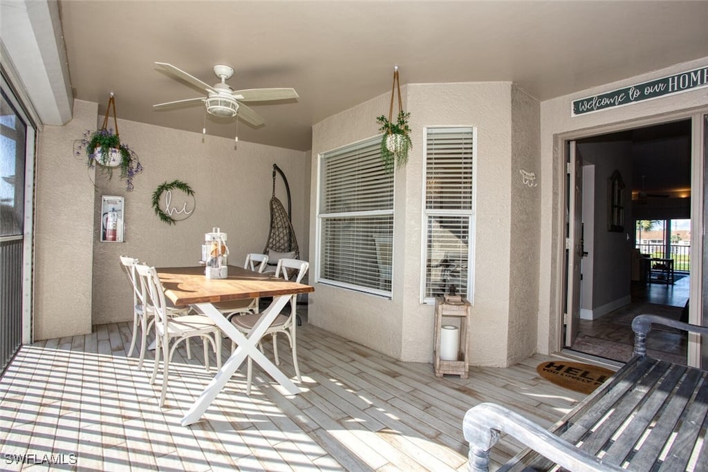 sunroom / solarium featuring ceiling fan