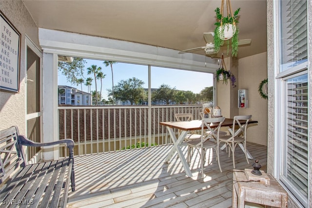 sunroom / solarium featuring ceiling fan