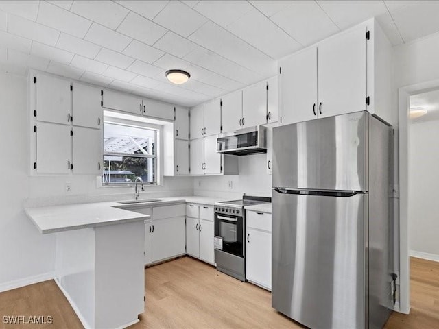 kitchen featuring light hardwood / wood-style floors, white cabinetry, and appliances with stainless steel finishes