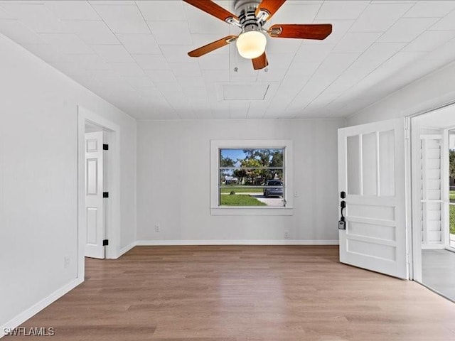 empty room with ceiling fan and light wood-type flooring