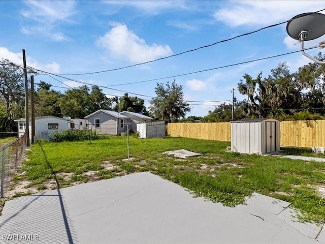 view of yard featuring a patio area and a storage unit