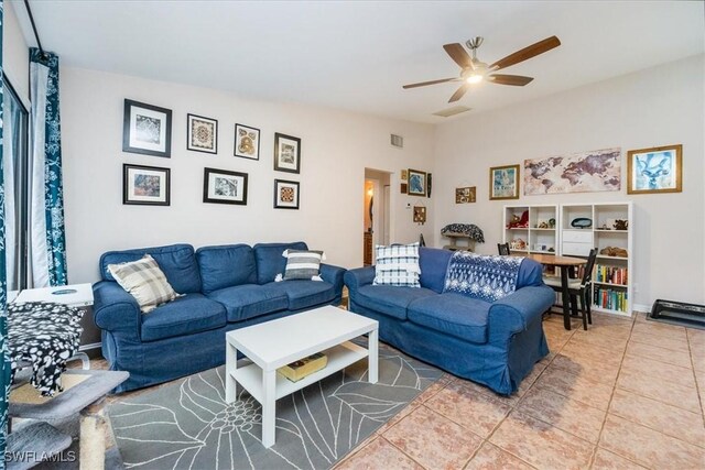 living room featuring ceiling fan and tile patterned floors